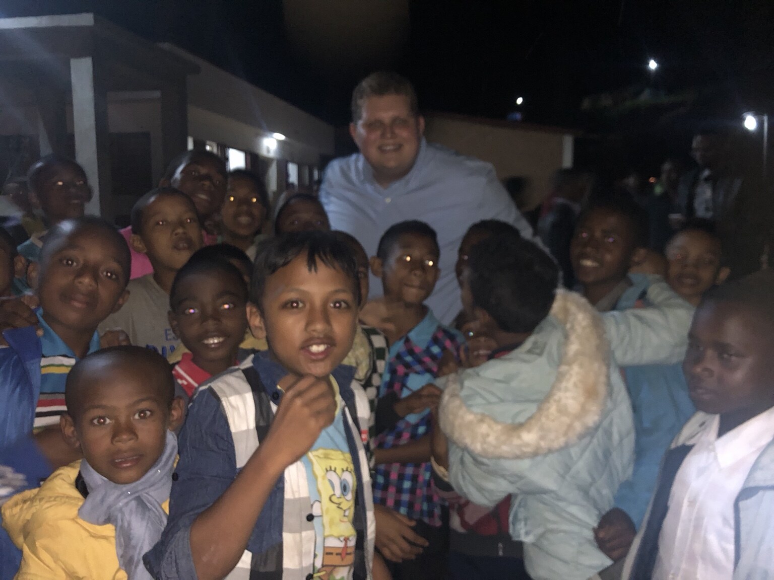 Children gathered together outdoors at night in Madagascar