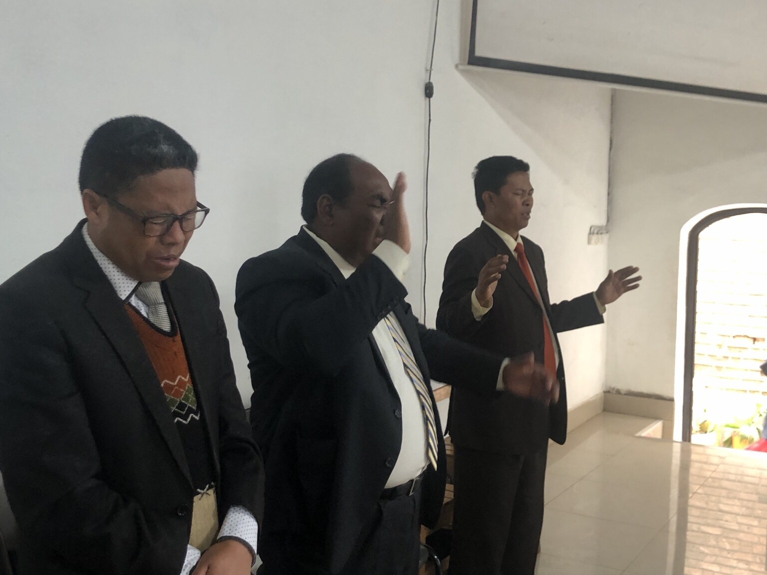 Three local ministry leaders praying together