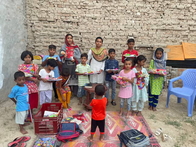 Children receiving supplies through local partners in Pakistan
